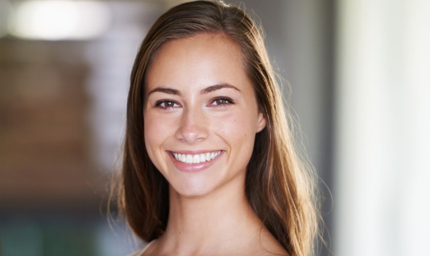 a beautiful girl smiling after receiving teeth whitening treatments at VIP Dental Lounge